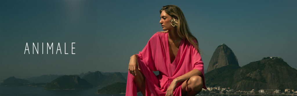 Modelo vestindo roupa rosa com vista para o Pão de Açúcar