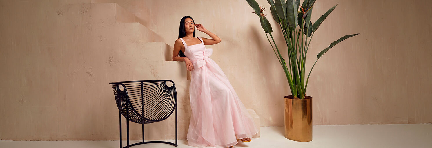 Mulher em vestido rosa em ambiente elegante